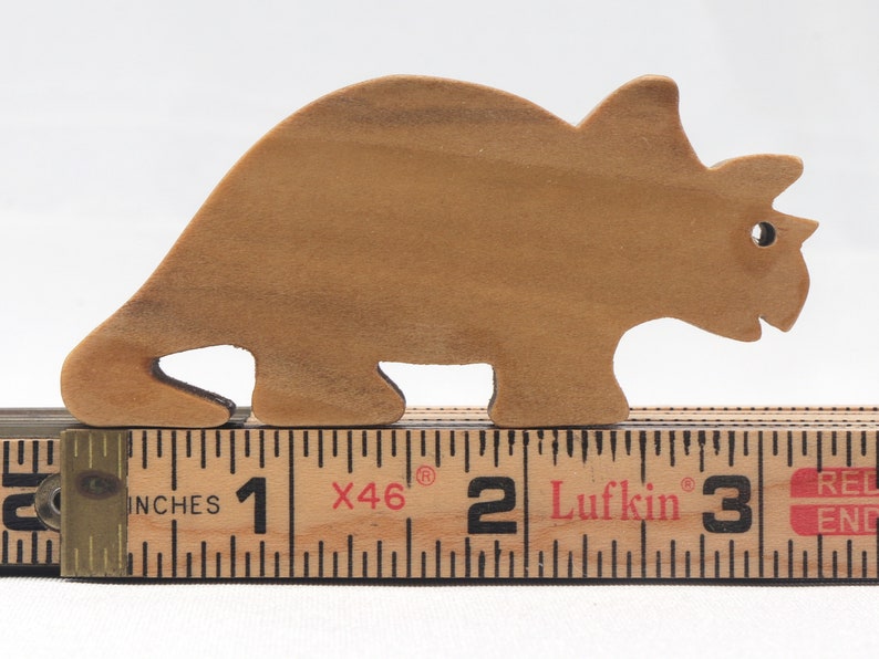 This small wooden triceratops dinosaur toy is crafted from high-quality hardwood and hand-finished. It is a delightful plaything for young children and appeals to many adults.