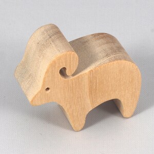 This is an unfinished wooden Ram cutout from solid wood using traditional woodworking techniques. Sanded smooth and ready to paint, stain, or customize. Freestanding design for small hands, toddlers, young children, crafters, collectors, and display. I take custom orders for any animal, quantity, and mix — including large ornament orders. Mix and match, request a different size, or send a drawing or pattern. Handmade by Odin's Toy Factory in Tallahassee, Florida, USA.