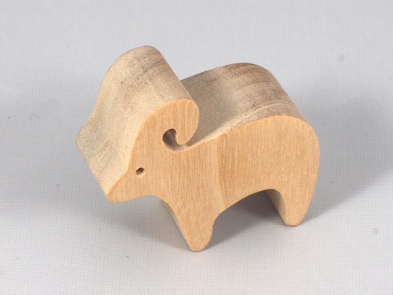 This is an unfinished wooden Ram cutout from solid wood using traditional woodworking techniques. Sanded smooth and ready to paint, stain, or customize. Freestanding design for small hands, toddlers, young children, crafters, collectors, and display. I take custom orders for any animal, quantity, and mix — including large ornament orders. Mix and match, request a different size, or send a drawing or pattern. Handmade by Odin's Toy Factory in Tallahassee, Florida, USA.