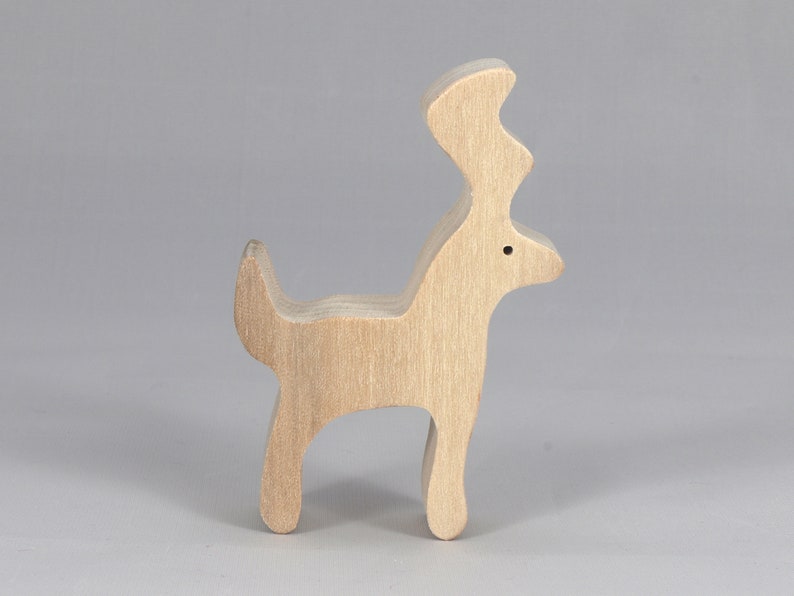 Handmade unfinished wooden deer toy figurine, part of the Itty Bitty Animal Collection, shown in natural light wood with visible grain, standing on a white background.