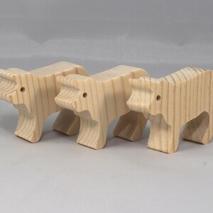 This is an unfinished wooden Calf cutout from solid wood using traditional woodworking techniques. Sanded smooth and ready to paint, stain, or customize. Freestanding design for small hands, toddlers, young children, crafters, collectors, and display. I take custom orders for any animal, quantity, and mix — including large ornament orders. Mix and match, request a different size, or send a drawing or pattern. Handmade by Odin's Toy Factory in Tallahassee, Florida, USA.