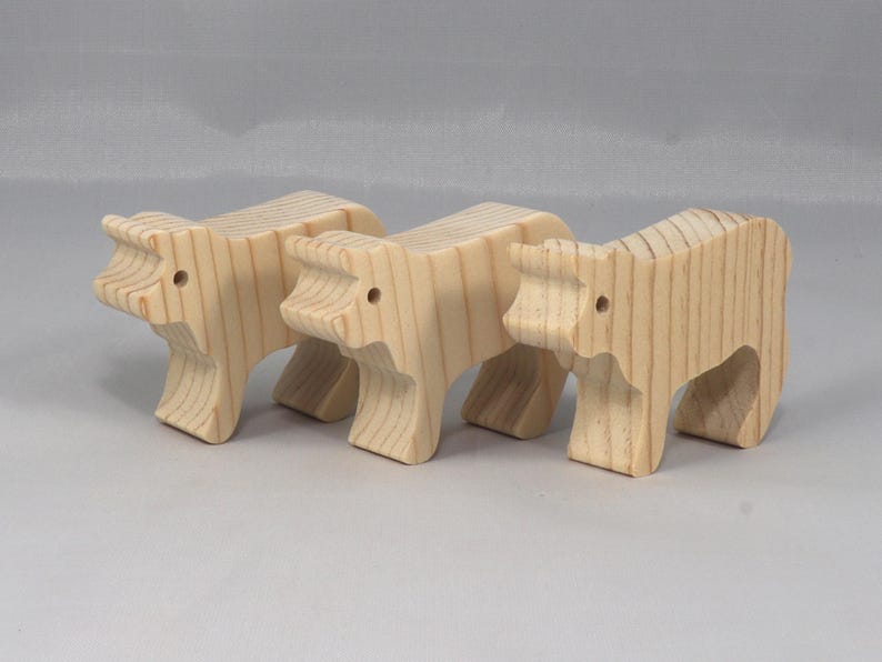 This is an unfinished wooden Calf cutout from solid wood using traditional woodworking techniques. Sanded smooth and ready to paint, stain, or customize. Freestanding design for small hands, toddlers, young children, crafters, collectors, and display. I take custom orders for any animal, quantity, and mix — including large ornament orders. Mix and match, request a different size, or send a drawing or pattern. Handmade by Odin's Toy Factory in Tallahassee, Florida, USA.