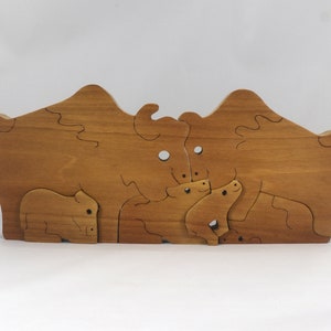 Wooden 6-piece bison family puzzle with two adult bison and four calves. The hardwood pieces interlock into one standing group or separate to stand alone. Handnmade in Tallahassee, Florida, USA by Odin's Toy Factory.