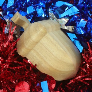 Handmade wooden miniature birdhouse ornament cut from wood with rounded edges, natural wood grain and color variations, finished with non-toxic shellac or food-safe oils and beeswax, lightweight and ready to hang. Made in Tallahassee, Florida, USA, by Odin's Toy Factory.