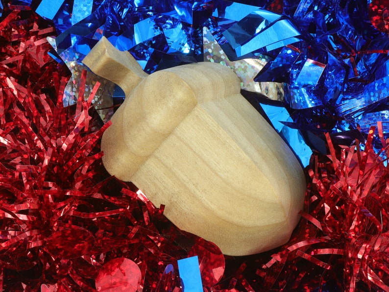 Handmade wooden miniature birdhouse ornament cut from wood with rounded edges, natural wood grain and color variations, finished with non-toxic shellac or food-safe oils and beeswax, lightweight and ready to hang. Made in Tallahassee, Florida, USA, by Odin's Toy Factory.