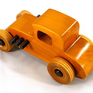 Handmade Wood Toy Car Hot Rod Based On The 1927 T-Coupe. It Has Been Hand-Finished With Multiple Coats Of Amber Shellac And Trimmed With Black Acrylic Paint.