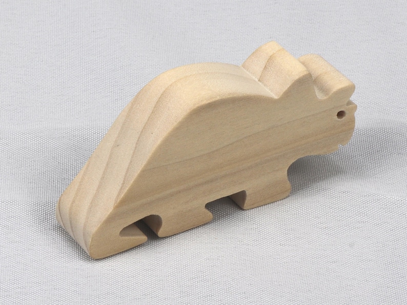 This is an unfinished wooden Wooden Toy Dinosaur Triceratops cutout from solid wood using traditional woodworking techniques. Sanded smooth and ready to paint, stain, or customize. Freestanding design for small hands, toddlers, young children, crafters, collectors, and display. I take custom orders for any animal, quantity, and mix — including large ornament orders. Mix and match, request a different size, or send a drawing or pattern. Handmade by Odin's Toy Factory in Tallahassee, Florida, USA.