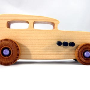 Handmade wooden toy car Hot Rod '32 Sedan finished with polyurethane, metallic purple and black trim, and nonmarring amber shellac wheels.