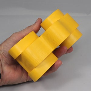 Handmade wooden toy car vintage style of a fat fendered coupe painted bright yellow with nonmarring amber shellac finished wheels. It is an excellent push toy for a younger child.