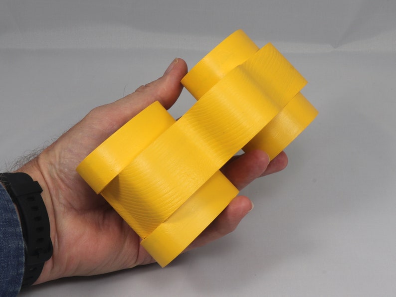 Handmade wooden toy car vintage style of a fat fendered coupe painted bright yellow with nonmarring amber shellac finished wheels. It is an excellent push toy for a younger child.