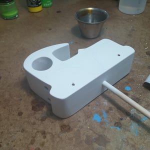 Odin' Toy Factory Toymakers Shop Photo - A wooden toy car body with white primer applied. White primer produces the brightest colors, especially when painting with lighter colors. I apply it in thin coats, sanding between coats until I get complete coverage.
