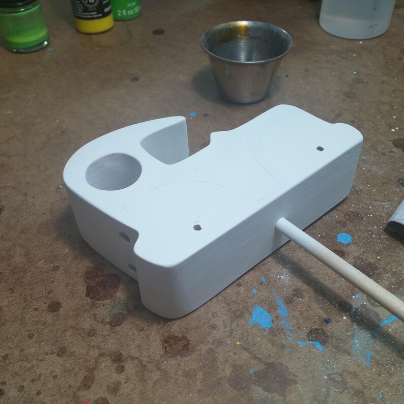 Odin' Toy Factory Toymakers Shop Photo - A wooden toy car body with white primer applied. White primer produces the brightest colors, especially when painting with lighter colors. I apply it in thin coats, sanding between coats until I get complete coverage.
