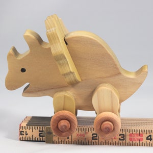 Handmade wooden push toy Triceratops dinosaur made from select grade hardwoods and finished with a non-toxic coating.