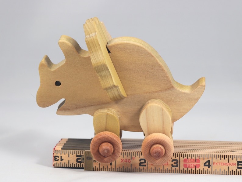 Handmade wooden push toy Triceratops dinosaur made from select grade hardwoods and finished with a non-toxic coating.
