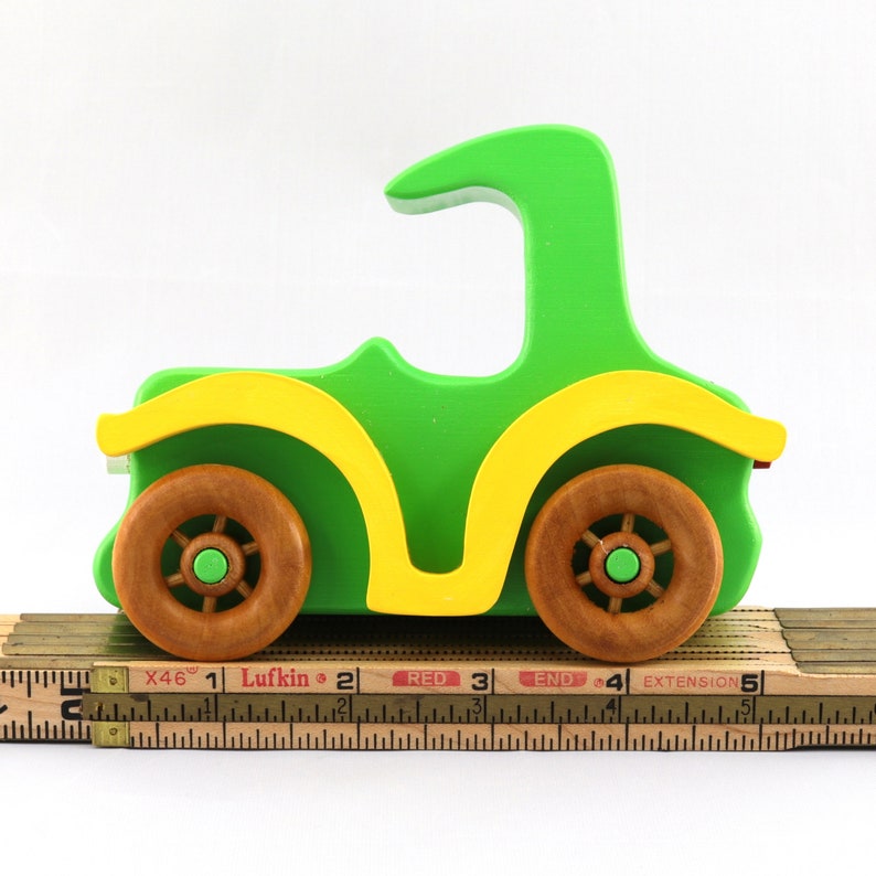 Handmade wooden toy car, vintage-style Model T sedan, painted bright green and yellow with spoked wheels, finished in amber shellac.  Handcrafted in Tallahassee, Florida, USA by Odin's Toy Factory.