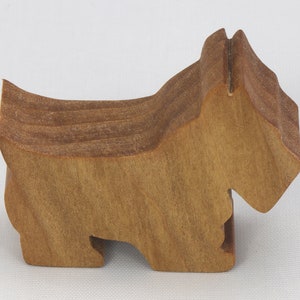 Handmade wooden Scottie dog toy cutout finished with mineral oil and beeswax blend. Freestanding stackable design from my Itty Bitty Animal Collection. Handcrafted in Tallahassee, Florida, USA from quality hardwood. Approximate size: length 2-1/2 inches, height 2 inches, width 3/4 inch. Each piece is unique with natural wood grain variations.