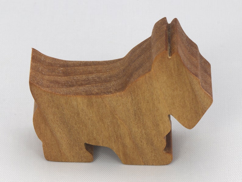 Handmade wooden Scottie dog toy cutout finished with mineral oil and beeswax blend. Freestanding stackable design from my Itty Bitty Animal Collection. Handcrafted in Tallahassee, Florida, USA from quality hardwood. Approximate size: length 2-1/2 inches, height 2 inches, width 3/4 inch. Each piece is unique with natural wood grain variations.