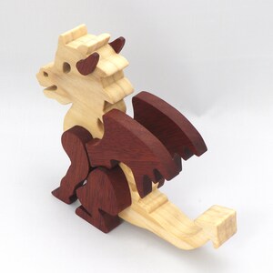 Hand-crafted baby dragon mythical fantasy animal figurine made from contrasting high-quality hardwoods and finished with non-toxic oils and waxes. Perfect for any dragon enthusiast.