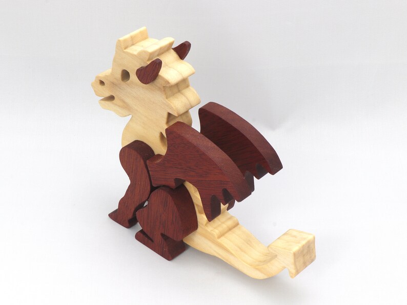 Hand-crafted baby dragon mythical fantasy animal figurine made from contrasting high-quality hardwoods and finished with non-toxic oils and waxes. Perfect for any dragon enthusiast.