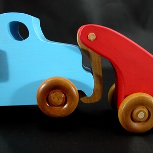 This handmade wooden Lorry truck is finished with navy blue acrylic paint and Amber Shellac. It is one of five towable trucks in this collection, available in many colors and unfinished. Custom Orders are welcome.