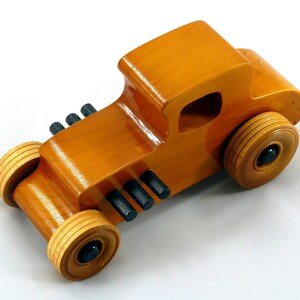 Handmade Wood Toy Car Hot Rod Based On The 1927 T-Coupe. It Has Been Hand-Finished With Multiple Coats Of Amber Shellac And Trimmed With Black Acrylic Paint.