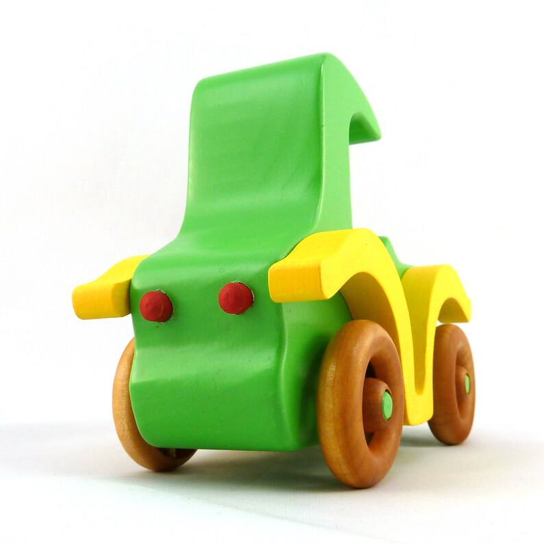 Handmade wooden toy car, vintage-style Model T sedan, painted bright green and yellow with spoked wheels, finished in amber shellac.  Handcrafted in Tallahassee, Florida, USA by Odin's Toy Factory.