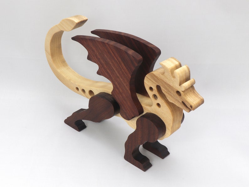 Handmade wood dragon figurine made from select grade contrasting hardwoods and hand-finished with a custom mixture of mineral oil and waxes.