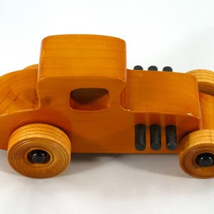 Handmade Wood Toy Car Hot Rod Based On The 1927 T-Coupe. It Has Been Hand-Finished With Multiple Coats Of Amber Shellac And Trimmed With Black Acrylic Paint.
