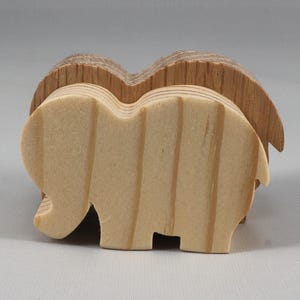 This is an unfinished wooden Elephant cutout from solid wood using traditional woodworking techniques. Sanded smooth and ready to paint, stain, or customize. Freestanding design for small hands, toddlers, young children, crafters, collectors, and display. I take custom orders for any animal, quantity, and mix — including large ornament orders. Mix and match, request a different size, or send a drawing or pattern. Handmade by Odin's Toy Factory in Tallahassee, Florida, USA.