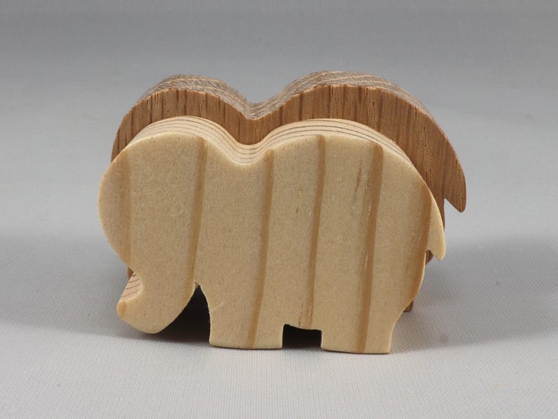 This is an unfinished wooden Elephant cutout from solid wood using traditional woodworking techniques. Sanded smooth and ready to paint, stain, or customize. Freestanding design for small hands, toddlers, young children, crafters, collectors, and display. I take custom orders for any animal, quantity, and mix — including large ornament orders. Mix and match, request a different size, or send a drawing or pattern. Handmade by Odin's Toy Factory in Tallahassee, Florida, USA.