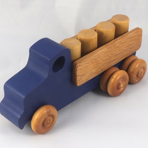 This handmade wooden Lorry truck is finished with navy blue acrylic paint and Amber Shellac. It is one of five towable trucks in this collection, available in many colors and unfinished. Custom Orders are welcome.