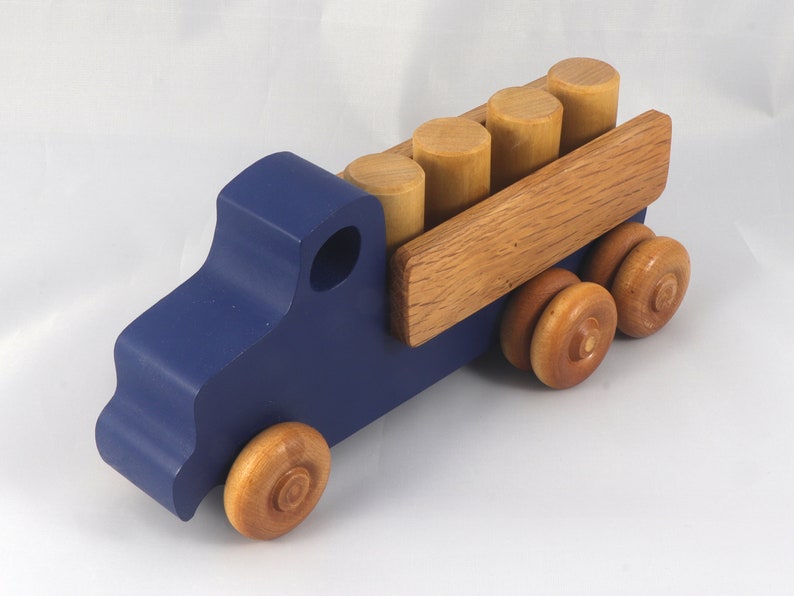 This handmade wooden Lorry truck is finished with navy blue acrylic paint and Amber Shellac. It is one of five towable trucks in this collection, available in many colors and unfinished. Custom Orders are welcome.