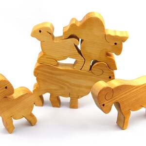 Handmade wooden toy stacking puzzle with five freestanding goats finished with a custom blend of nontoxic oils and waxes.