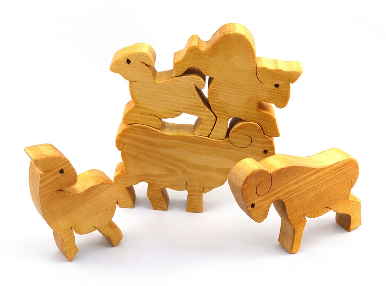 Handmade wooden toy stacking puzzle with five freestanding goats finished with a custom blend of nontoxic oils and waxes.