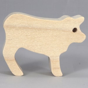 Handmade unfinished wooden toy baby calf cutout, unpainted and ready to paint, freestanding farm animal figure from Odin's Toy Factory’s  Itty Bitty Animal Collection. Handcrafted in Tallahassee, Florida, USA, using reclaimed natural wood offcuts. Perfect for imaginative play, stacking, collectors, and crafting.