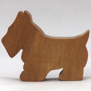 Handmade wooden Scottie dog toy cutout finished with mineral oil and beeswax blend. Freestanding stackable design from my Itty Bitty Animal Collection. Handcrafted in Tallahassee, Florida, USA from quality hardwood. Approximate size: length 2-1/2 inches, height 2 inches, width 3/4 inch. Each piece is unique with natural wood grain variations.