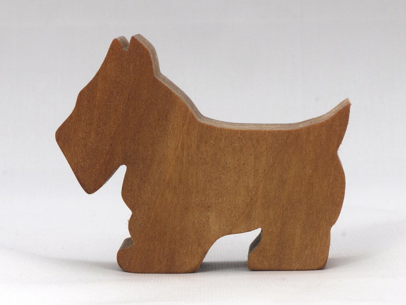 Handmade wooden Scottie dog toy cutout finished with mineral oil and beeswax blend. Freestanding stackable design from my Itty Bitty Animal Collection. Handcrafted in Tallahassee, Florida, USA from quality hardwood. Approximate size: length 2-1/2 inches, height 2 inches, width 3/4 inch. Each piece is unique with natural wood grain variations.