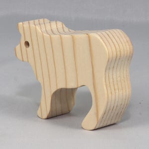 This is an unfinished wooden Calf cutout from solid wood using traditional woodworking techniques. Sanded smooth and ready to paint, stain, or customize. Freestanding design for small hands, toddlers, young children, crafters, collectors, and display. I take custom orders for any animal, quantity, and mix — including large ornament orders. Mix and match, request a different size, or send a drawing or pattern. Handmade by Odin's Toy Factory in Tallahassee, Florida, USA.