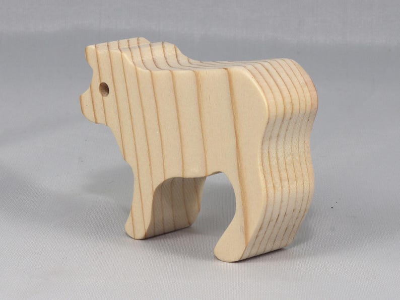 This is an unfinished wooden Calf cutout from solid wood using traditional woodworking techniques. Sanded smooth and ready to paint, stain, or customize. Freestanding design for small hands, toddlers, young children, crafters, collectors, and display. I take custom orders for any animal, quantity, and mix — including large ornament orders. Mix and match, request a different size, or send a drawing or pattern. Handmade by Odin's Toy Factory in Tallahassee, Florida, USA.