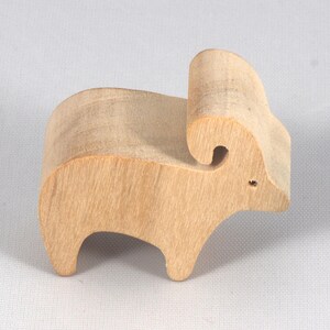 This is an unfinished wooden Ram cutout from solid wood using traditional woodworking techniques. Sanded smooth and ready to paint, stain, or customize. Freestanding design for small hands, toddlers, young children, crafters, collectors, and display. I take custom orders for any animal, quantity, and mix — including large ornament orders. Mix and match, request a different size, or send a drawing or pattern. Handmade by Odin's Toy Factory in Tallahassee, Florida, USA.