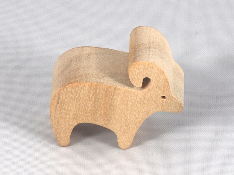This is an unfinished wooden Ram cutout from solid wood using traditional woodworking techniques. Sanded smooth and ready to paint, stain, or customize. Freestanding design for small hands, toddlers, young children, crafters, collectors, and display. I take custom orders for any animal, quantity, and mix — including large ornament orders. Mix and match, request a different size, or send a drawing or pattern. Handmade by Odin's Toy Factory in Tallahassee, Florida, USA.