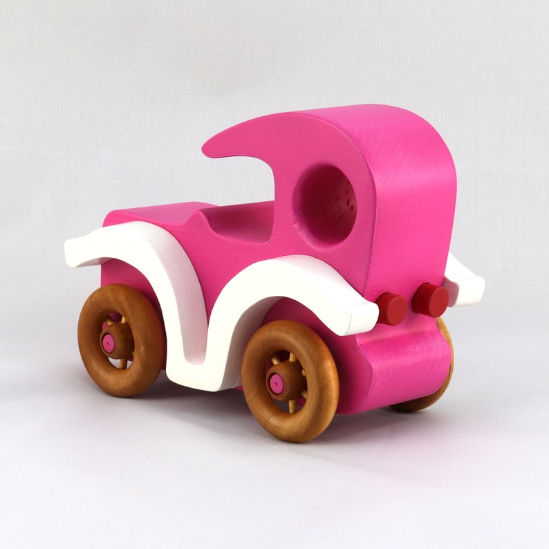 Handmade wooden toy car model-t sedan finished with hot pink and white acrylic paint with nonmaring amber shellac coated spoked wheels from my Bad Bob'S Custom Motors Collection.