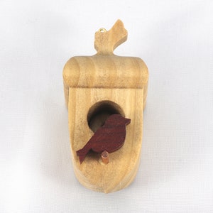 Handmade wooden miniature birdhouse ornament cut from wood with rounded edges, natural wood grain and color variations, finished with non-toxic shellac or food-safe oils and beeswax, lightweight and ready to hang. Made in Tallahassee, Florida, USA, by Odin's Toy Factory.