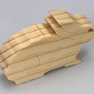 This is an unfinished wooden Rabbit cutout from solid wood using traditional woodworking techniques. Sanded smooth and ready to paint, stain, or customize. Freestanding design for small hands, toddlers, young children, crafters, collectors, and display. I take custom orders for any animal, quantity, and mix — including large ornament orders. Mix and match, request a different size, or send a drawing or pattern. Handmade by Odin's Toy Factory in Tallahassee, Florida, USA.