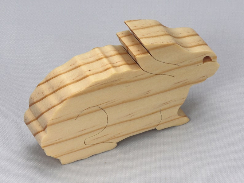 This is an unfinished wooden Rabbit cutout from solid wood using traditional woodworking techniques. Sanded smooth and ready to paint, stain, or customize. Freestanding design for small hands, toddlers, young children, crafters, collectors, and display. I take custom orders for any animal, quantity, and mix — including large ornament orders. Mix and match, request a different size, or send a drawing or pattern. Handmade by Odin's Toy Factory in Tallahassee, Florida, USA.