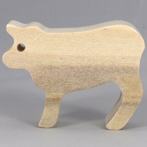 Handmade unfinished wooden toy baby calf cutout, unpainted and ready to paint, freestanding farm animal figure from Odin's Toy Factory’s  Itty Bitty Animal Collection. Handcrafted in Tallahassee, Florida, USA, using reclaimed natural wood offcuts. Perfect for imaginative play, stacking, collectors, and crafting.