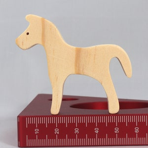Handmade wooden toy horse cutout, perfect for children's playtime collection. Freestanding and stackable, ready to paint or customize. Endless possibilities for imaginative play, from farm scenes to towering animal creations.