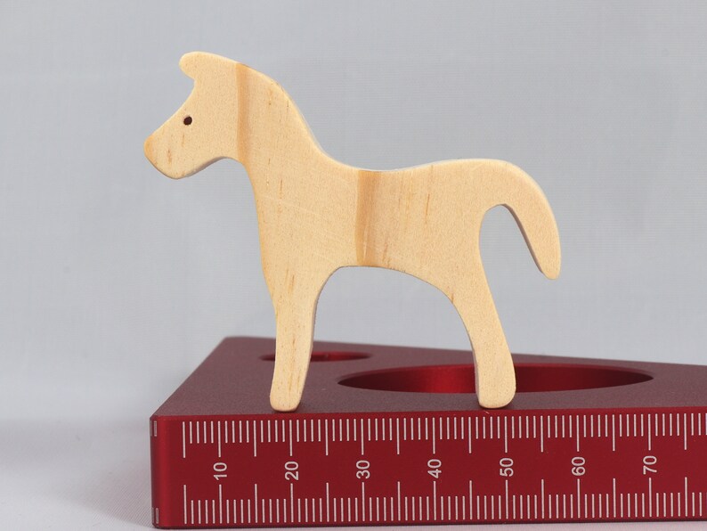 Handmade wooden toy horse cutout, perfect for children's playtime collection. Freestanding and stackable, ready to paint or customize. Endless possibilities for imaginative play, from farm scenes to towering animal creations.