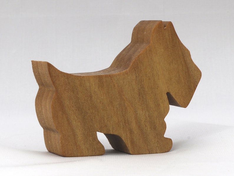 Handmade wooden Scottie dog toy cutout finished with mineral oil and beeswax blend. Freestanding stackable design from my Itty Bitty Animal Collection. Handcrafted in Tallahassee, Florida, USA from quality hardwood. Approximate size: length 2-1/2 inches, height 2 inches, width 3/4 inch. Each piece is unique with natural wood grain variations.