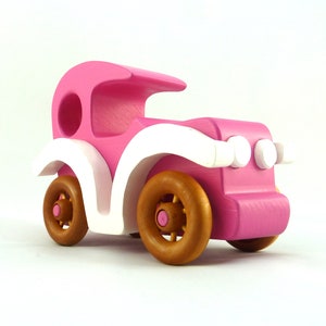 Handmade wooden toy car model-t sedan finished with hot pink and white acrylic paint with nonmaring amber shellac coated spoked wheels from my Bad Bob'S Custom Motors Collection.
